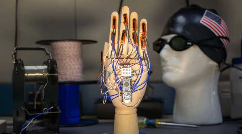 A hand mannequin with wires connected to a circuit board.